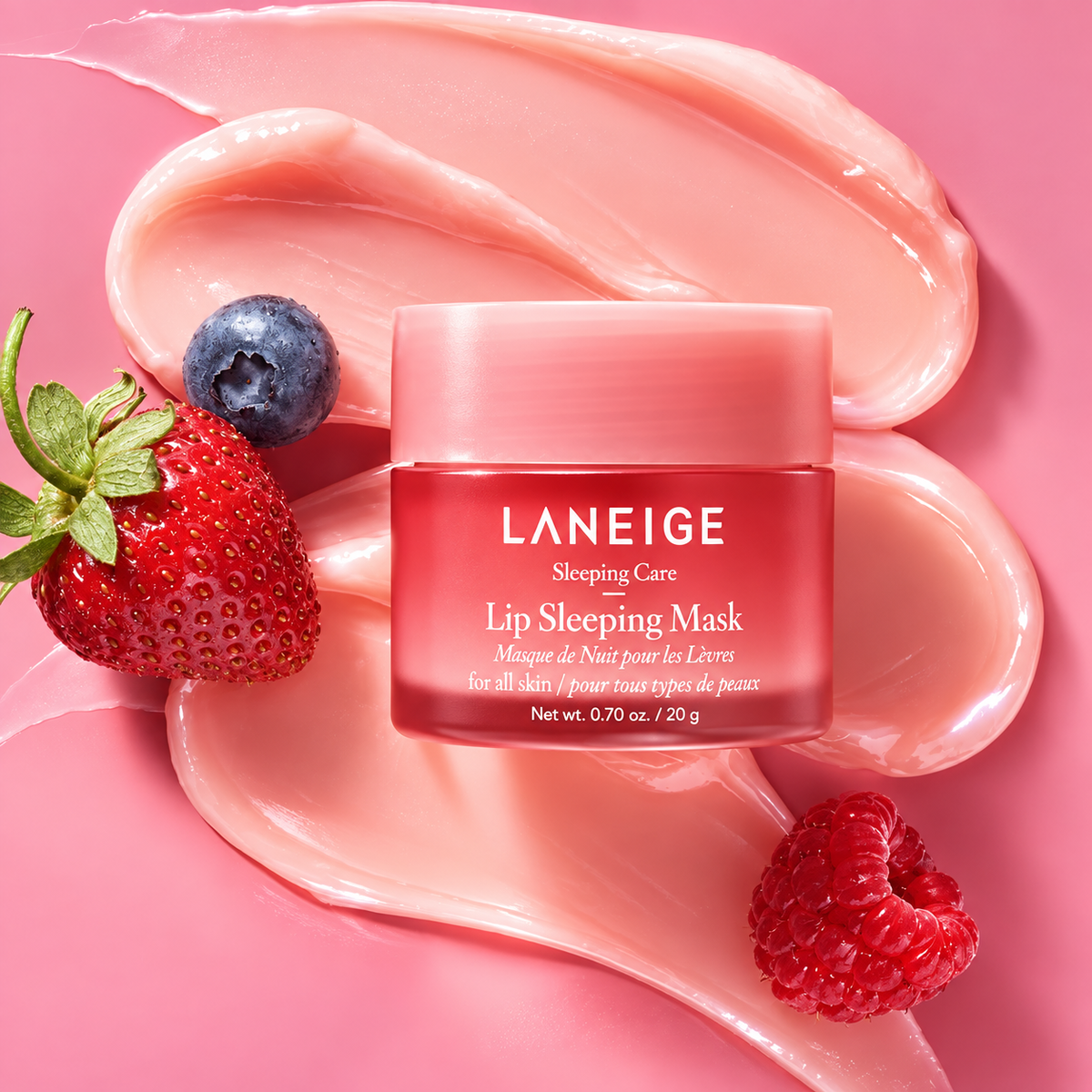 LANEIGE Lip Sleeping Mask EX Berry 20g jar on a pink cream swirl with raspberries and a blueberry.