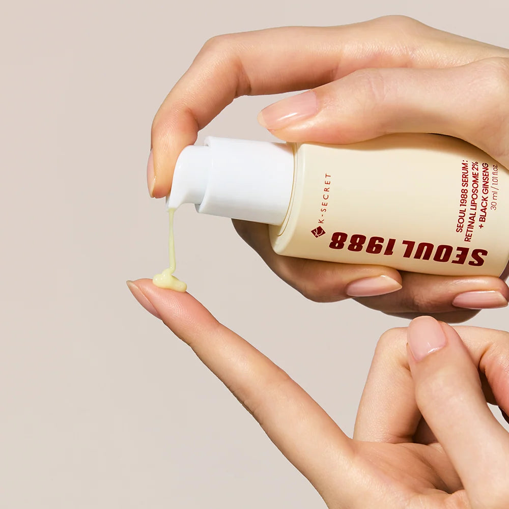 Hands holding the KSECRET Seoul 1988 serum bottle and dropper