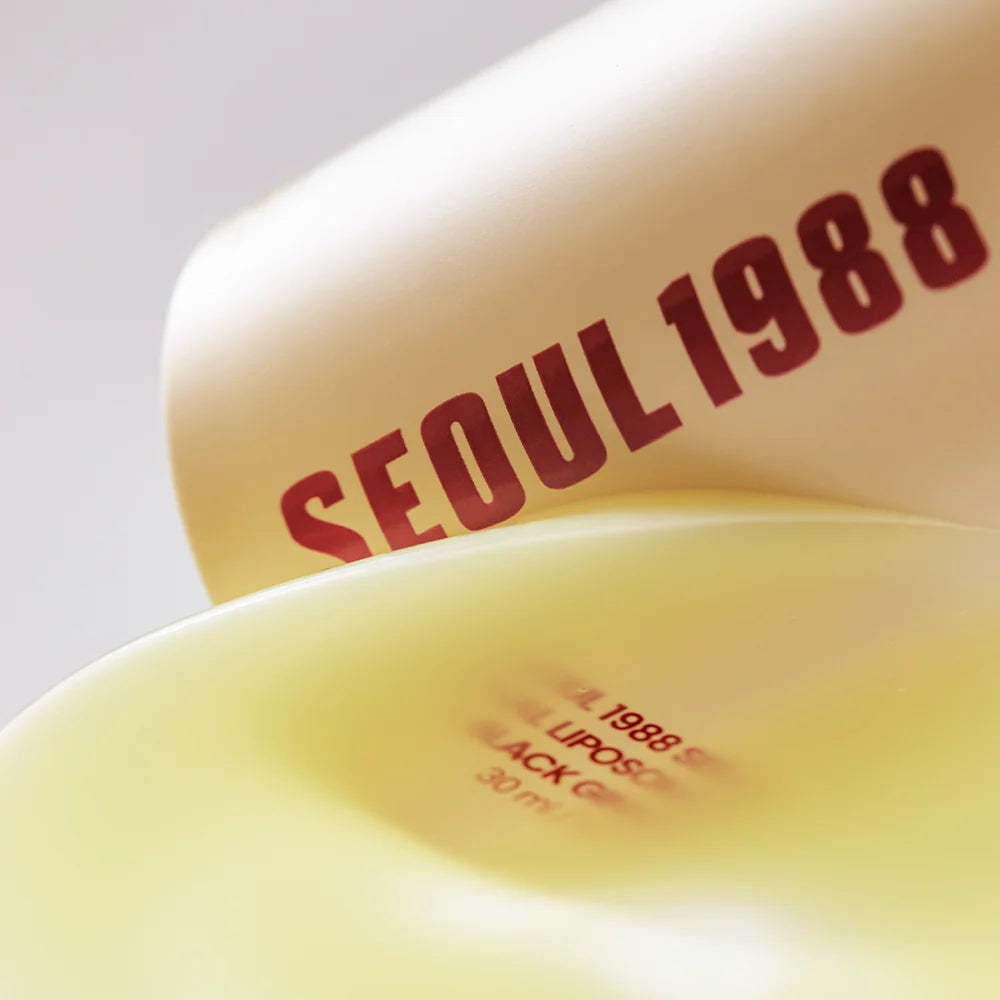 Close-up of KSECRET Seoul 1988 serum packaging and a drop of serum