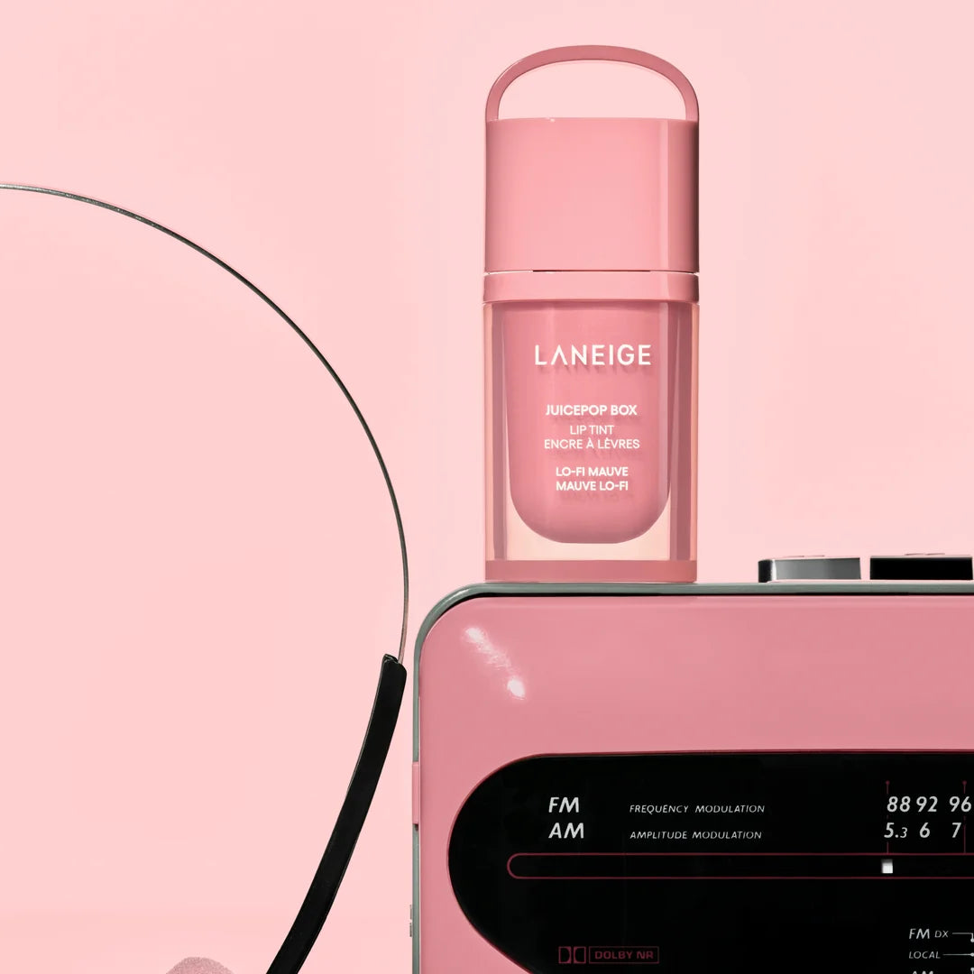 LANEIGE JuicePop Box Lip Tint Lo-Fi Mauve beside a pink radio on a pink background.
