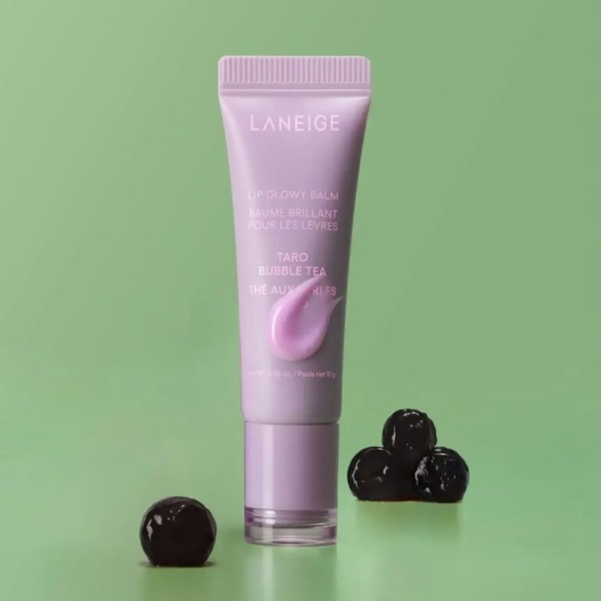 LANEIGE Lip Glowy Balm Taro 10g tube shown against a pale green background.